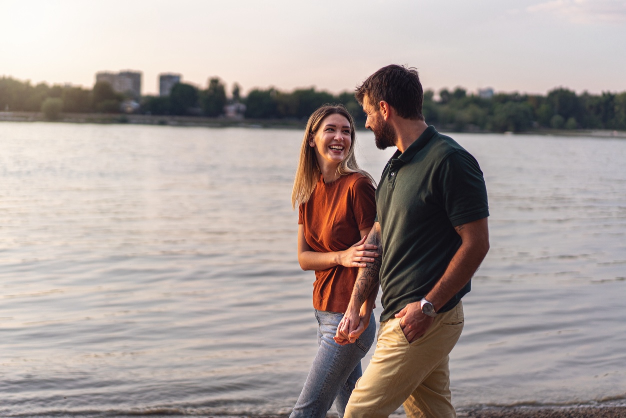 Couple walking along the waterfront during a relaxing weekend getaway